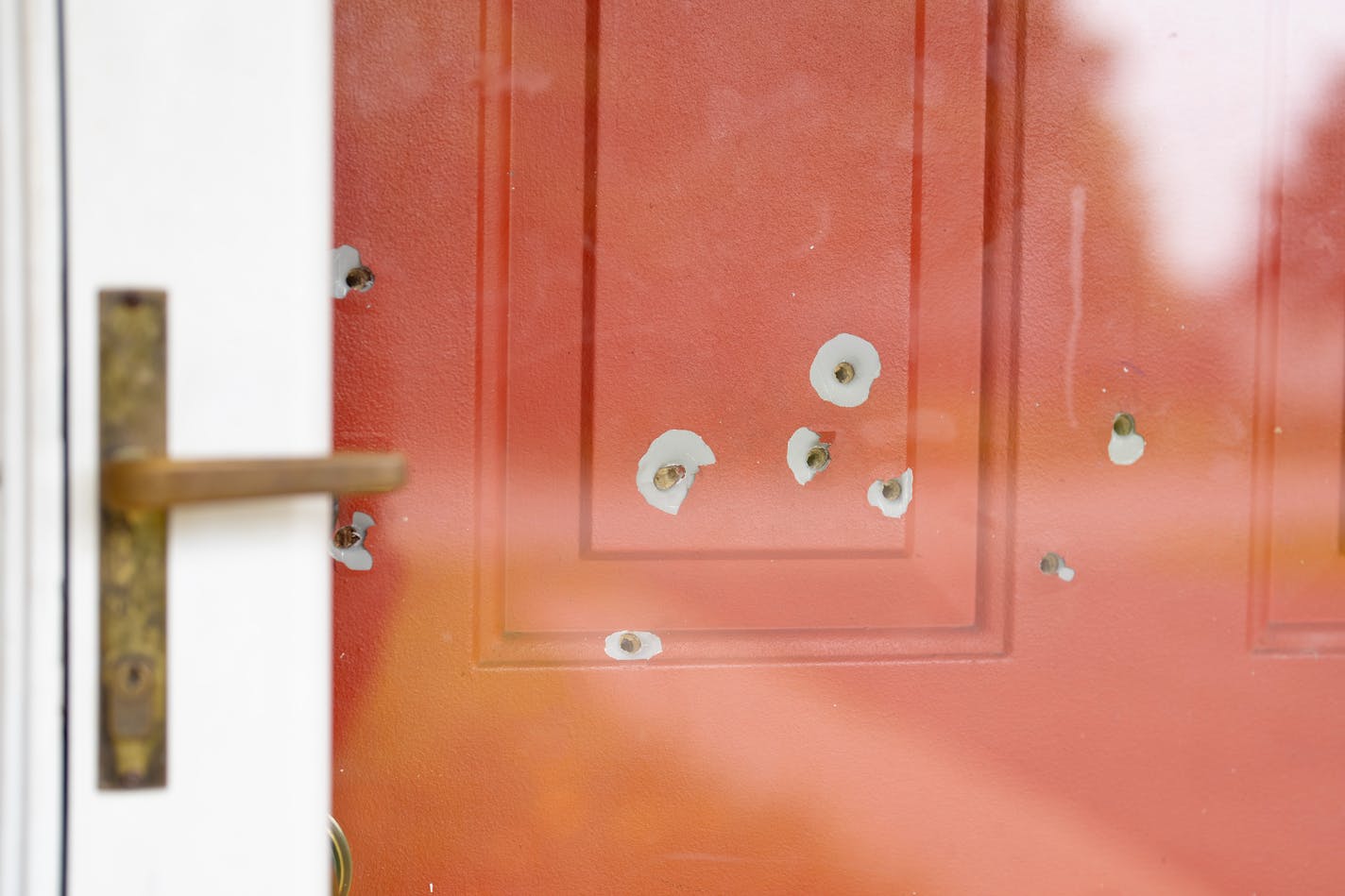 Bullet holes in the front door of Minnesota State Sen. John Hoffman’s home are visible in Champlin, Minn. on June 16.