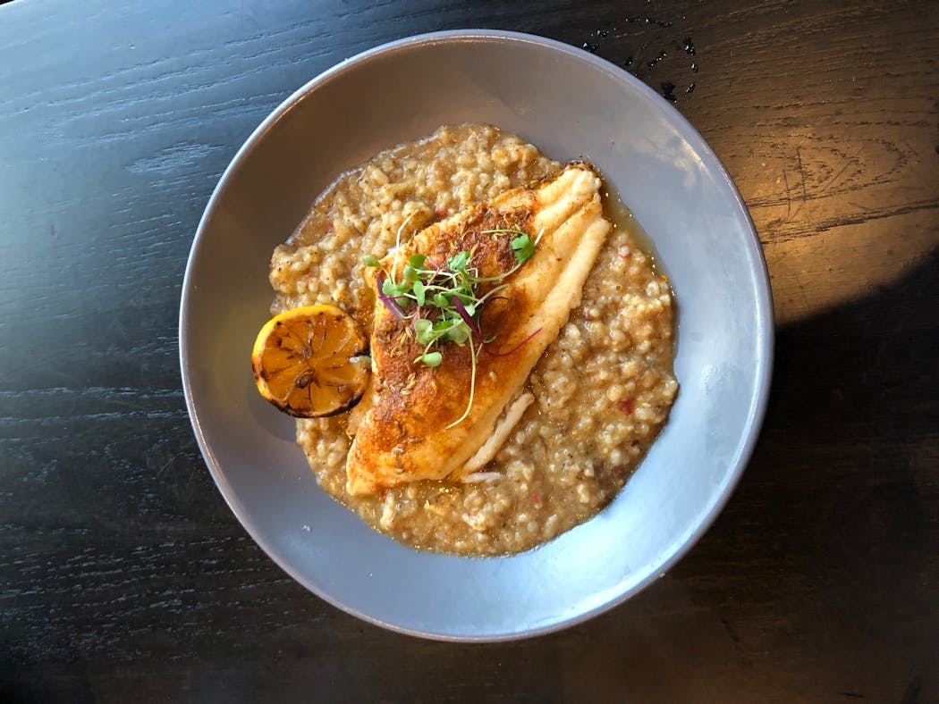 Blackened catfish is served with “dirty risotto” at the Shakopee House.