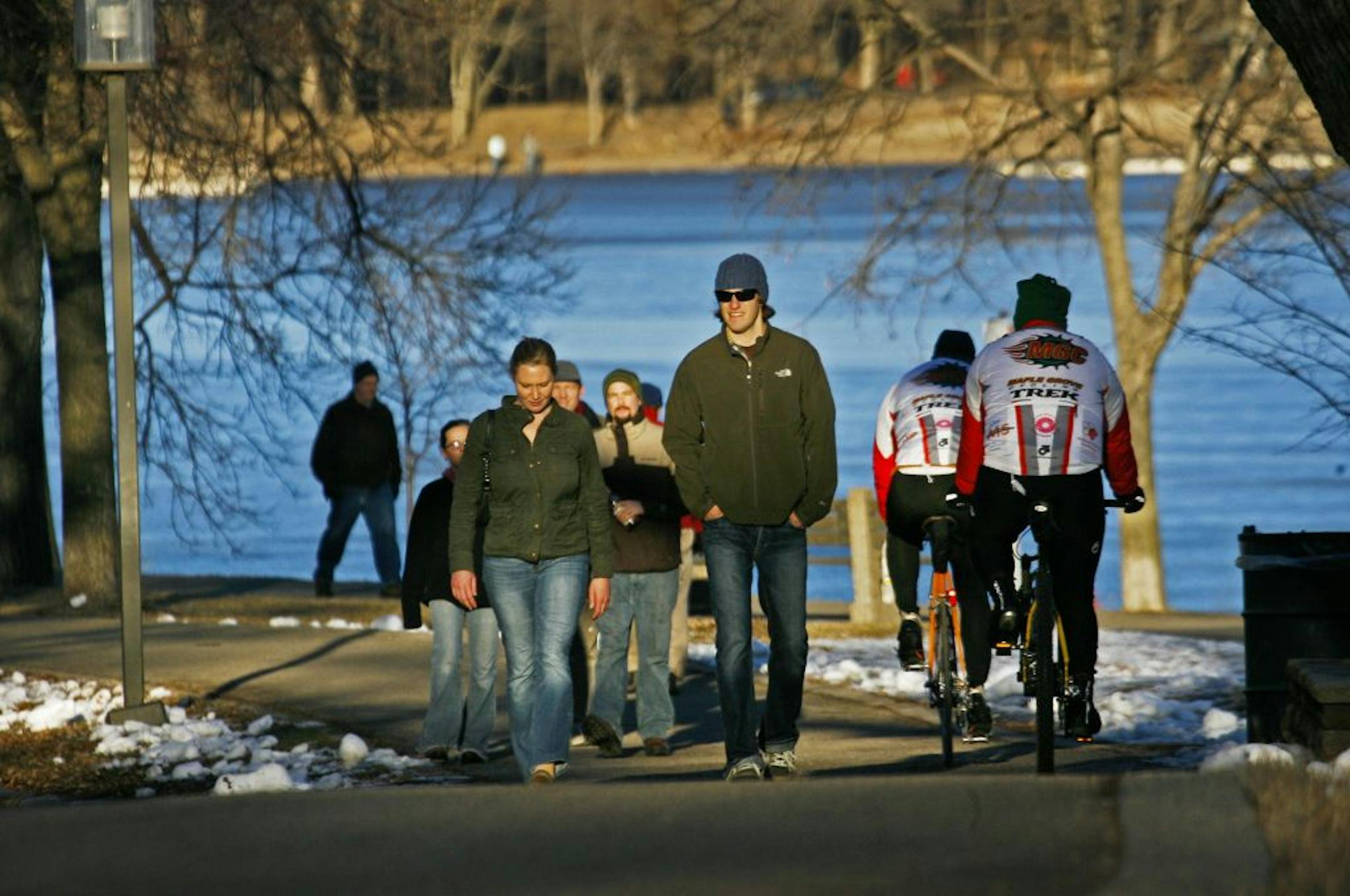 People flocked to local trails to take in near-record temps, including here along the edge of Lake Harriet Friday, Jan. 6, 2012.