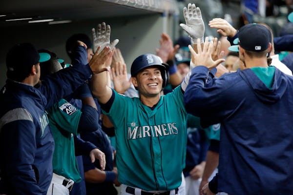 Seattle's Danny Valencia, a former Twins infielder, was congratulated by teammates on his three-run homer against Tampa Bay on Friday.