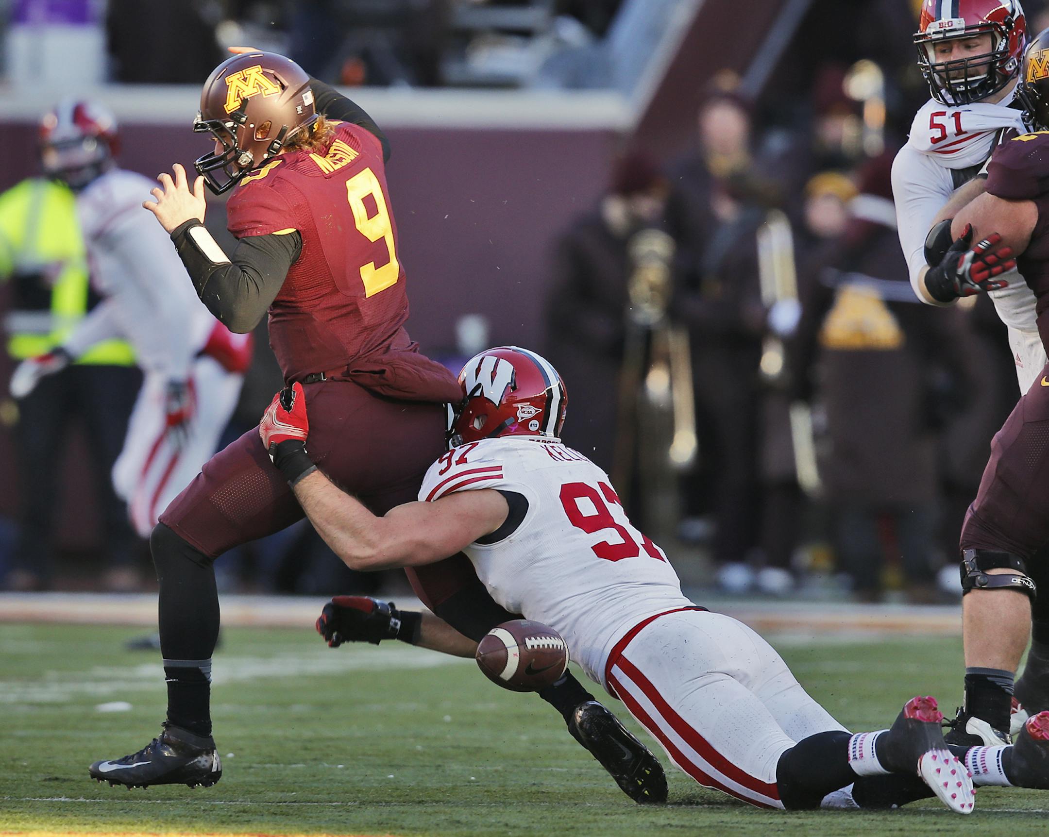 Minnesota Gophers vs. Wisconsin Badgers football. Wisconsin won 20-7. Minnesota quarterback Philip Nelson (9) fumbled the ball as Wisconsin's Brendan Kelly (97) tackled him in the second quarter. The ball was recovered by the Badgers. (MARLIN LEVISON/STARTRIBUNE(mlevison@startribune.com)