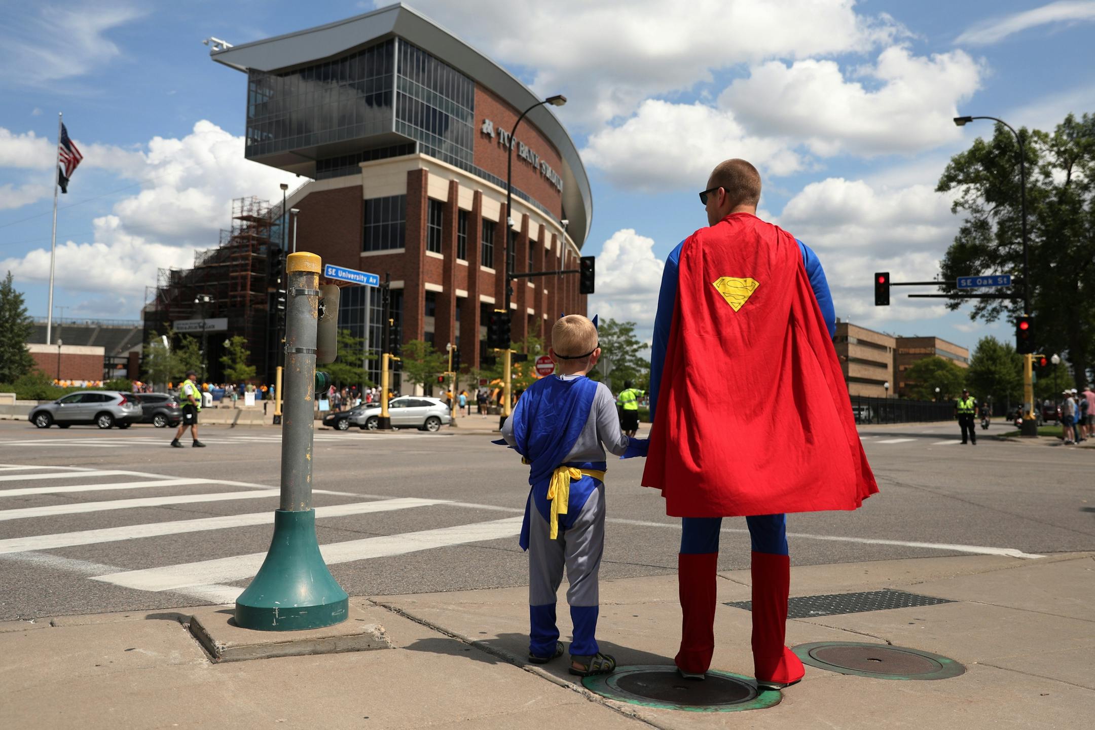 Minnesota United season ticket holders Josh Thompson and his son Franklin, 5, of Robbinsdale, Minn. waited to cross the street dressed as Batman and Superman on their way to Saturday's match.
