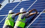 Workers finish constructing solar enery panels at Leech Lake Reservation ORG XMIT: IYYoMCNJWv_o_Ve0kGmr