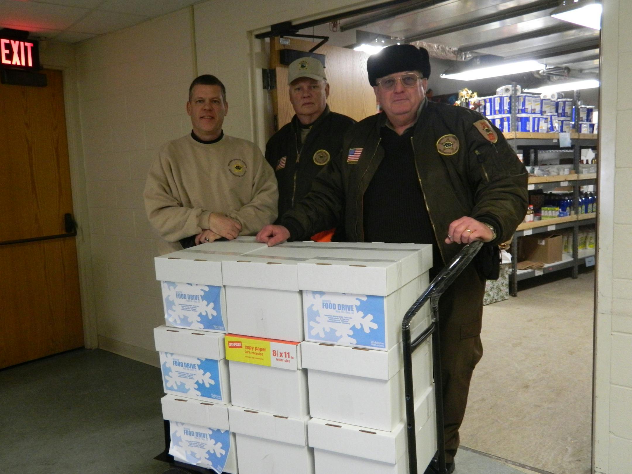 Reserves Sgt. Allan Pfromm, Cpl. Ray Hoyt and Sgt. Gary Glaeser of the Washington County Sheriff's Office delivered county employee contributions to area food shelves.