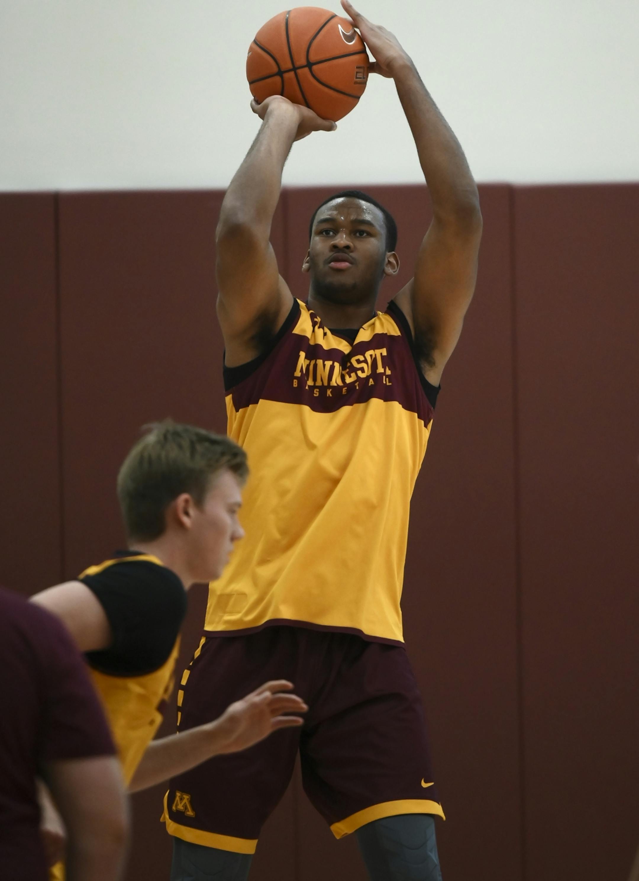 Minnesota Golden Gophers forward Eric Curry (24) attempted a shot during Tuesday's practice.