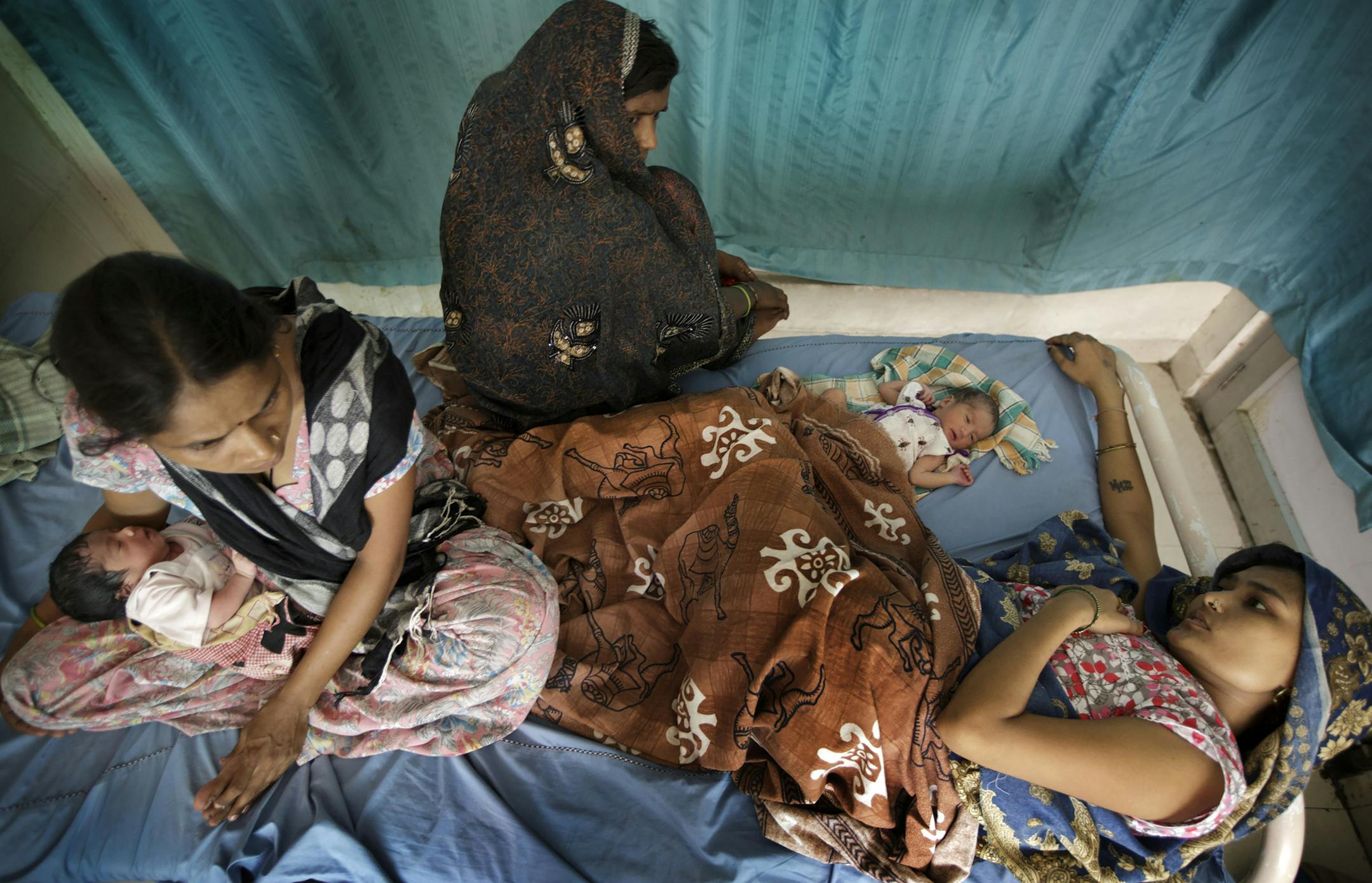 Mothers and newborn babies share a bed at the Civil Hospital in Gurgaon, India, Sept. 10, 2014. The poor health of children in India, which has about one-sixth of the world’s population but one-third of all newborn deaths, is one of the world’s most perplexing public health questions. (Kuni Takahashi/The New York Times)