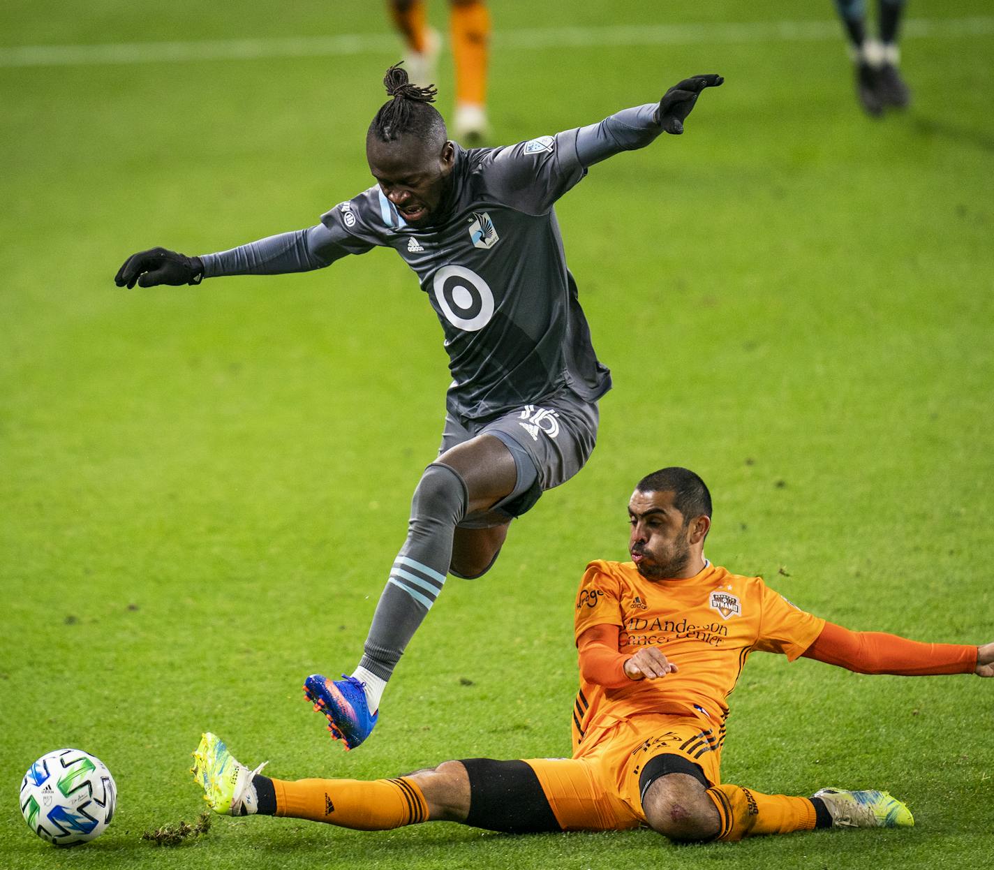 Minnesota United forward Kei Kamara (16) jumped over Houston Dynamo defender Victor Cabrera (36) during the second half of an MLS match in St. Paul, Minn., Sunday, Oct. 18, 2020. (Leila Navidi/Star Tribune via AP)