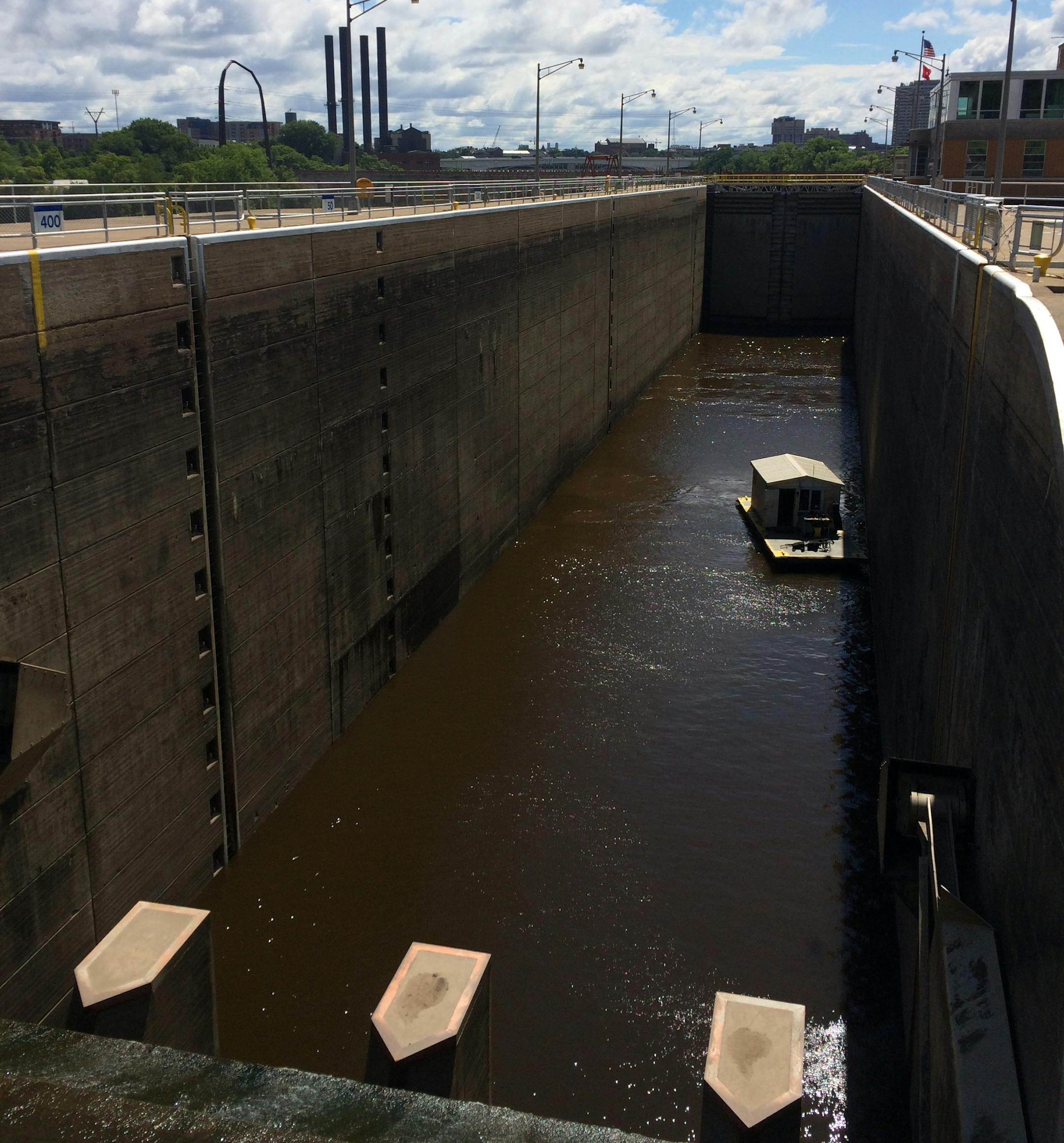 A maintenance boat of the U.S. Army Corps of Engineers waits as the Upper St. Anthony Falls lock fills on a recent weekday.