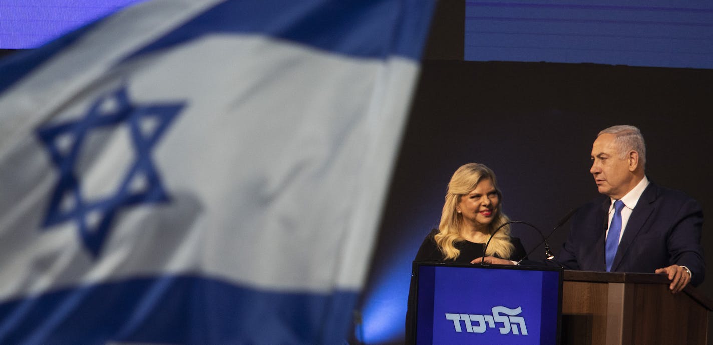 Israeli Prime Minister Benjamin Netanyahu and his wife, Sara, at a Likud election-night rally in Tel Aviv, Israel, April 9, 2019. Exit polls show a dead heat in the race between Benjamin Netanyahu, Likud's polarizing, right-wing prime minister, and his main rival, Benny Gantz, a retired general and political newcomer seen as a centrist. Both men claimed victory. (Dan Balilty/The New York Times)