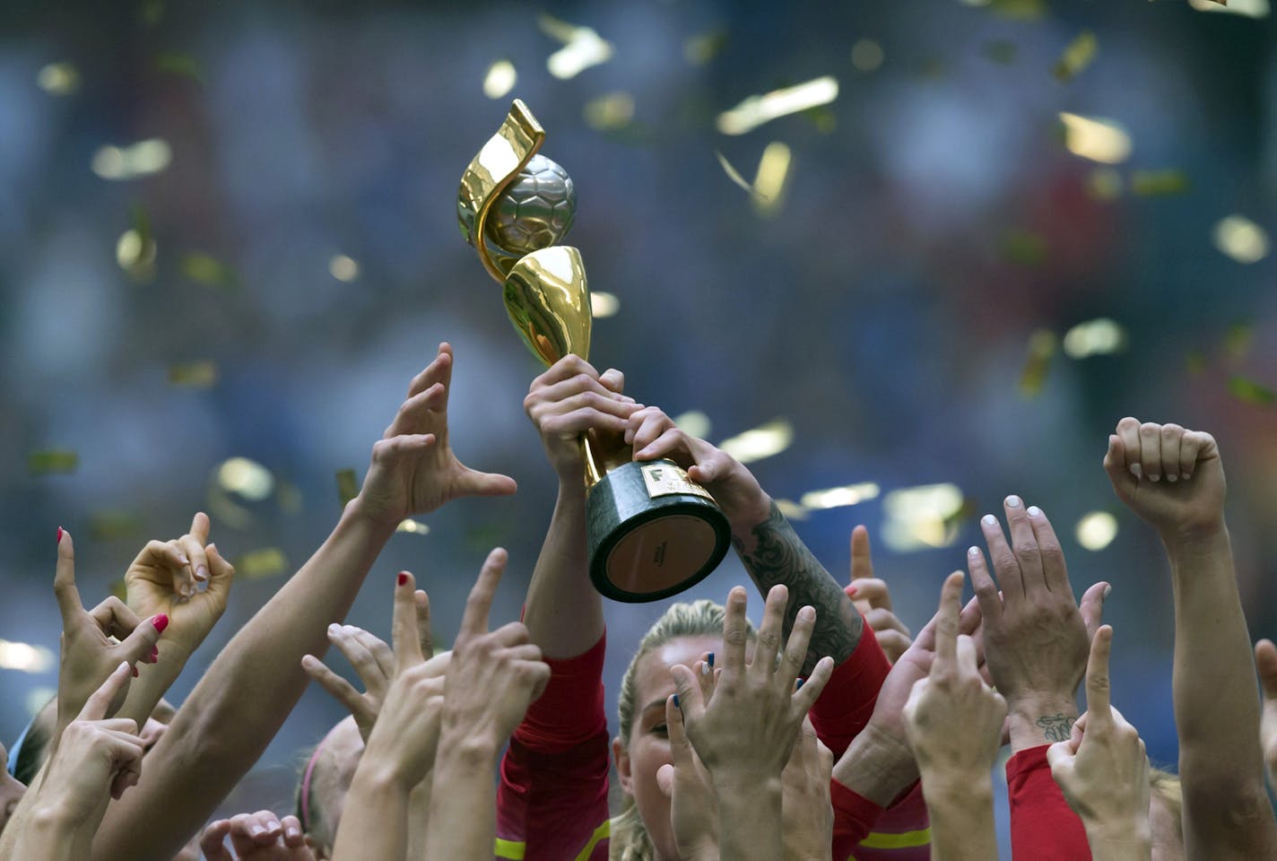 The United States Women's National Team celebrates with the trophy after they defeated Japan 5-2 in the FIFA Women's World Cup soccer championship in Vancouver, British Columbia, Canada, Sunday, July 5, 2015. (Darryl Dyck/The Canadian Press via AP) MANDATORY CREDIT