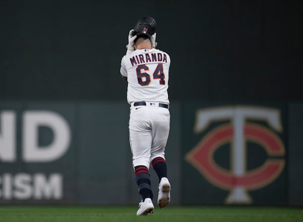 Minnesota Twins fist baseman Jose Miranda (64) holds his helmet after his fly ball was caught by the left fielder ending the game in the 11th inning.