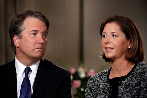 Brett Kavanaugh, left, looks at his wife Ashley Estes Kavanaugh as they answer questions during a FOX News interview, Monday, Sept. 24, 2018, in Washi