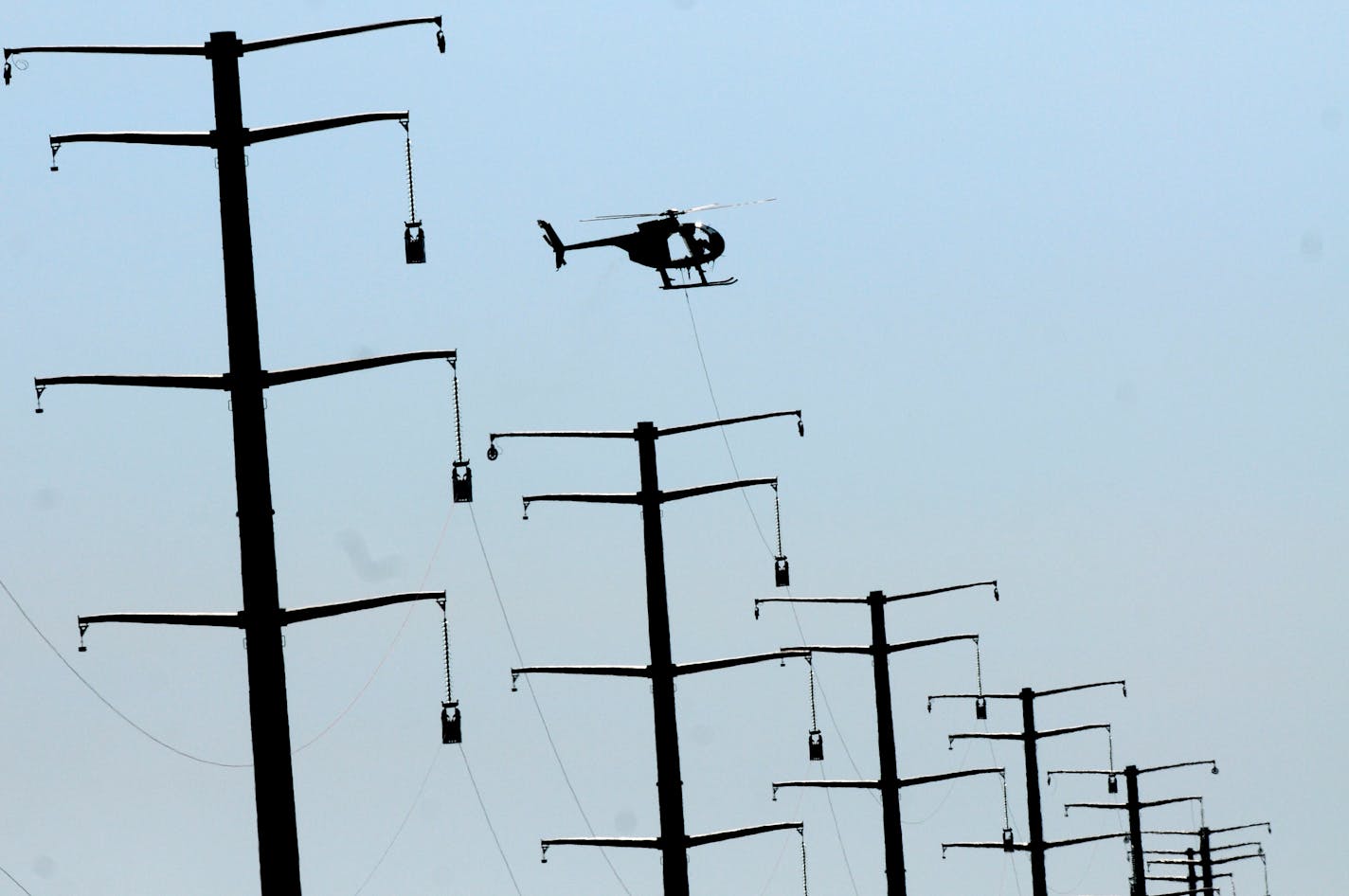 Conservationists propose that Xcel Energy apply tiered pricing to its Minnesota residential power customers, as it does in Colorado and as Minnesota Power does in the northern part of Minnesota. File photo of an Xcel power line being installed near St. Cloud in 2011.