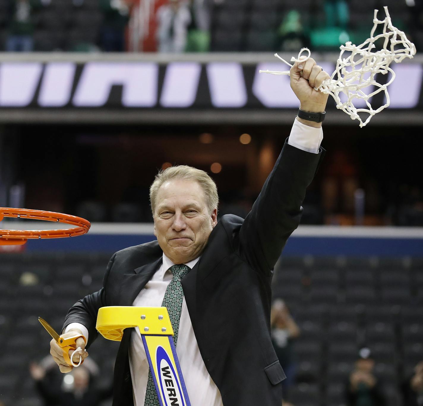 Michigan State head coach Tom Izzo holds up the net after defeating Duke in an NCAA men's East Regional final college basketball game in Washington, Sunday, March 31, 2019. Michigan State won 68-67. (AP Photo/Alex Brandon) ORG XMIT: VZN151