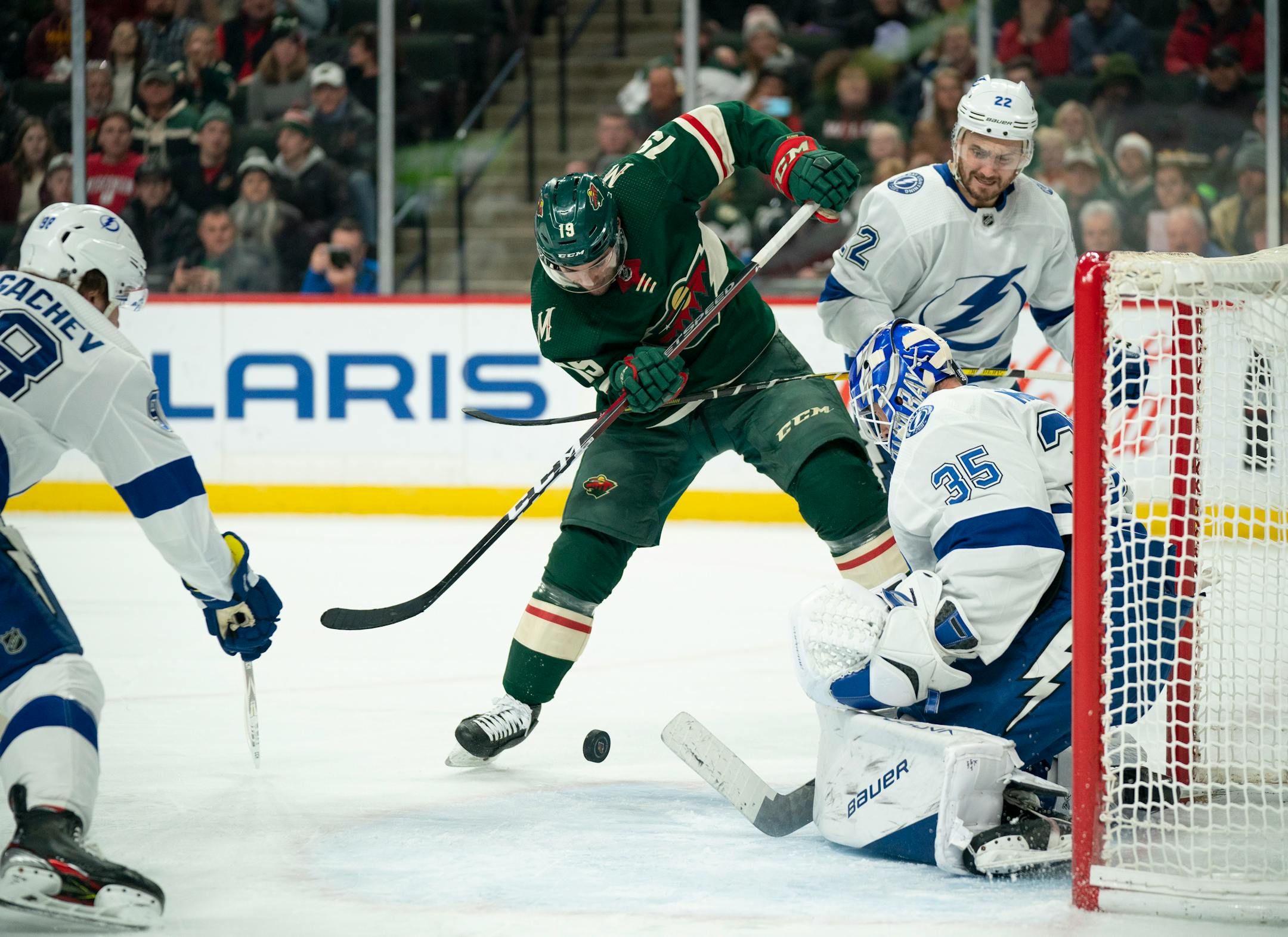 Wild center Luke Kunin slapped at a rebound in front of Lightning goaltender Curtis McElhinney