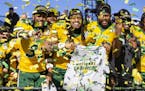 North Dakota State linebackers Jasir Cox (31), Aaron Mercadel (55), and Jabril Cox (42) celebrate after beating James Madison 28-20 in FCS championshi