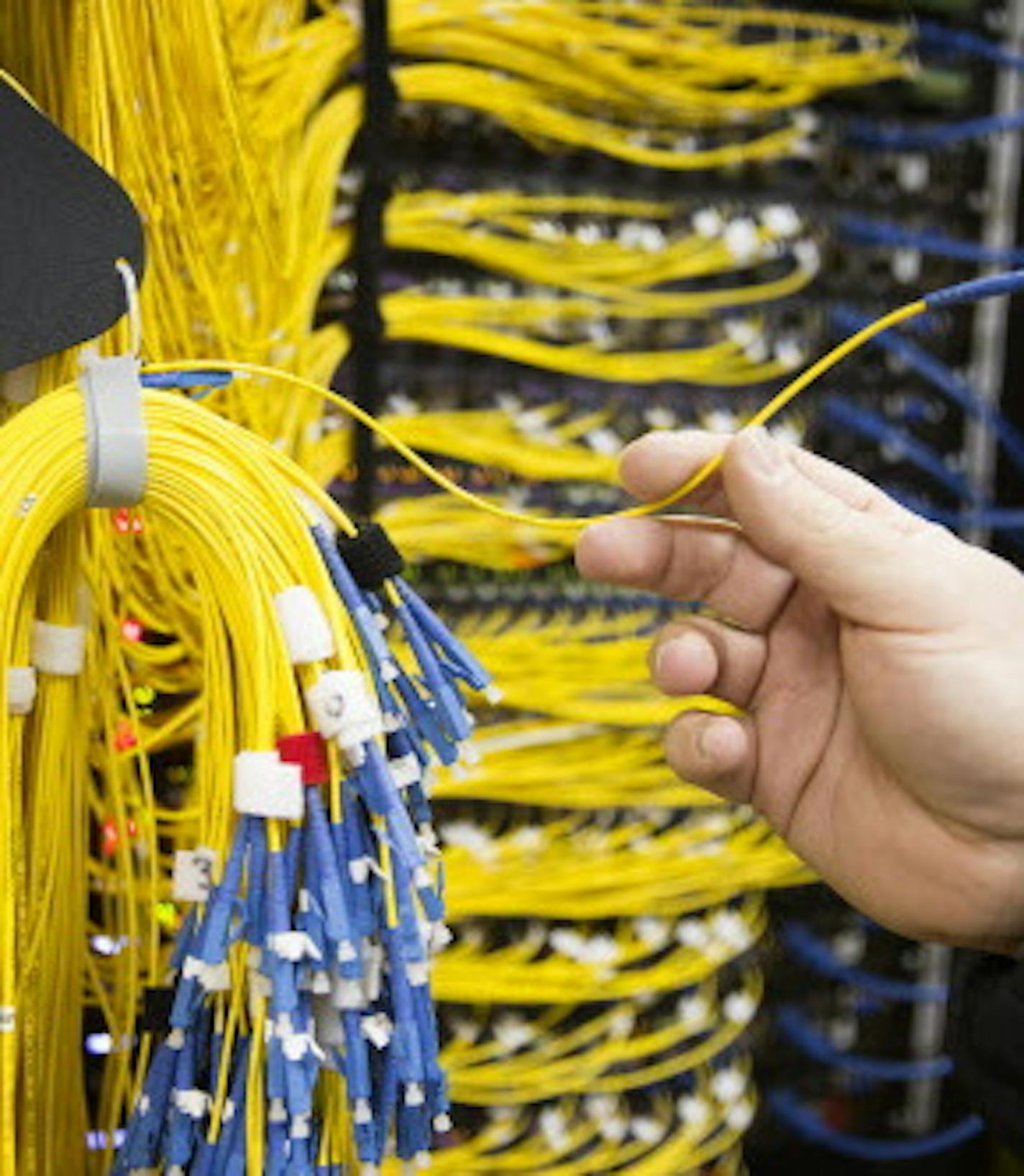 The individual fiber optic strands that will be plugged into switches once the properties are connected are seen inside the U.S. Internet switching station on Garfield Avenue near Lake Street in Minneapolis on Thursday, March 19, 2015. ] LEILA NAVIDI leila.navidi@startribune.com /