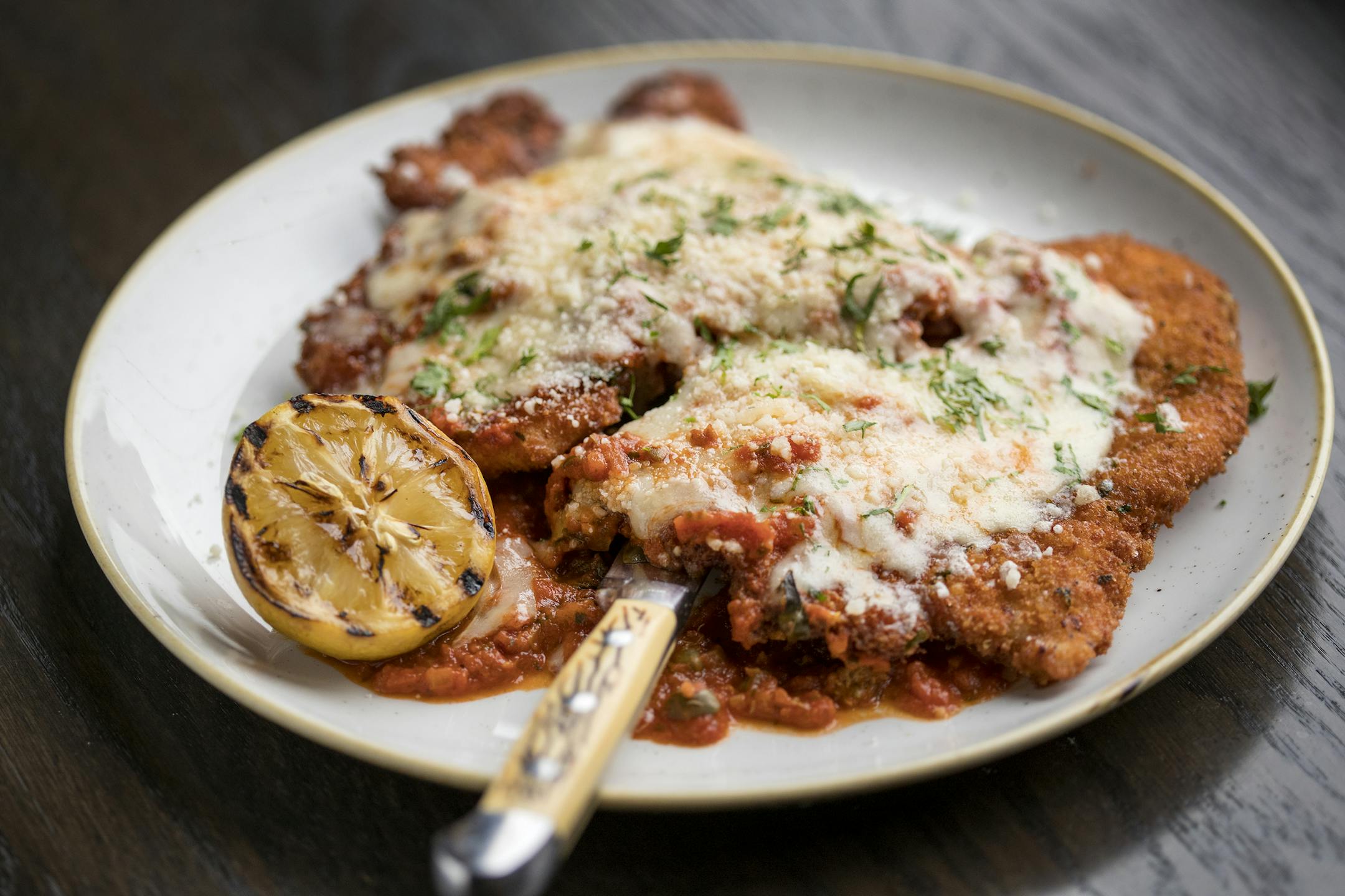 CHICKEN PARMESAN: Red sauce, fontina, parmesan, lemon at Red Rabbit.