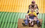 Dan Huse of Woodbury rides the giant slide with his son Calvin, 6, and twin four-year-old daughters Hana, left, and Lexi at the Minnesota State Fair o