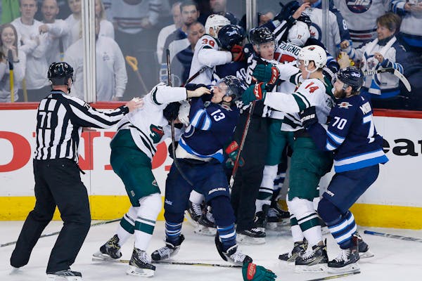 Winnipeg Jets and Minnesota Wild mix it up during the third period of Game 2