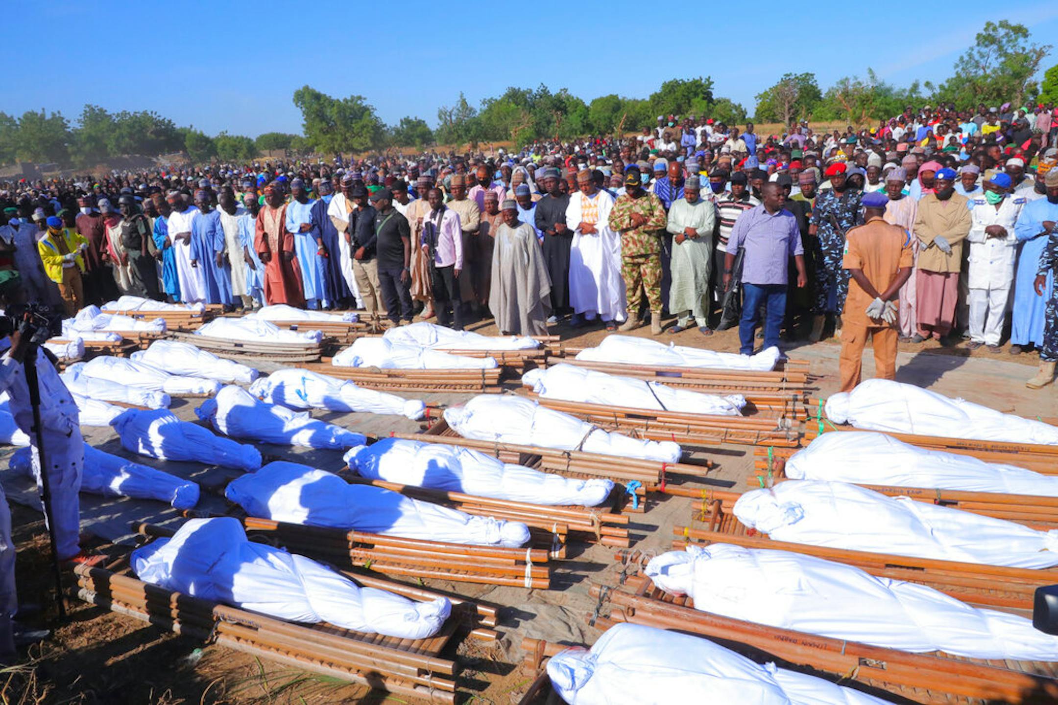 People attend a funeral for those killed by suspected Boko Haram militants in Zaabarmar, Nigeria, Sunday, Nov. 29, 2020.