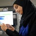 Amal Qasem, 15, an eighth grader in Efrain Tovar's newcomers class, shows how a math app she created works on a projection screen at Abraham Lincoln M