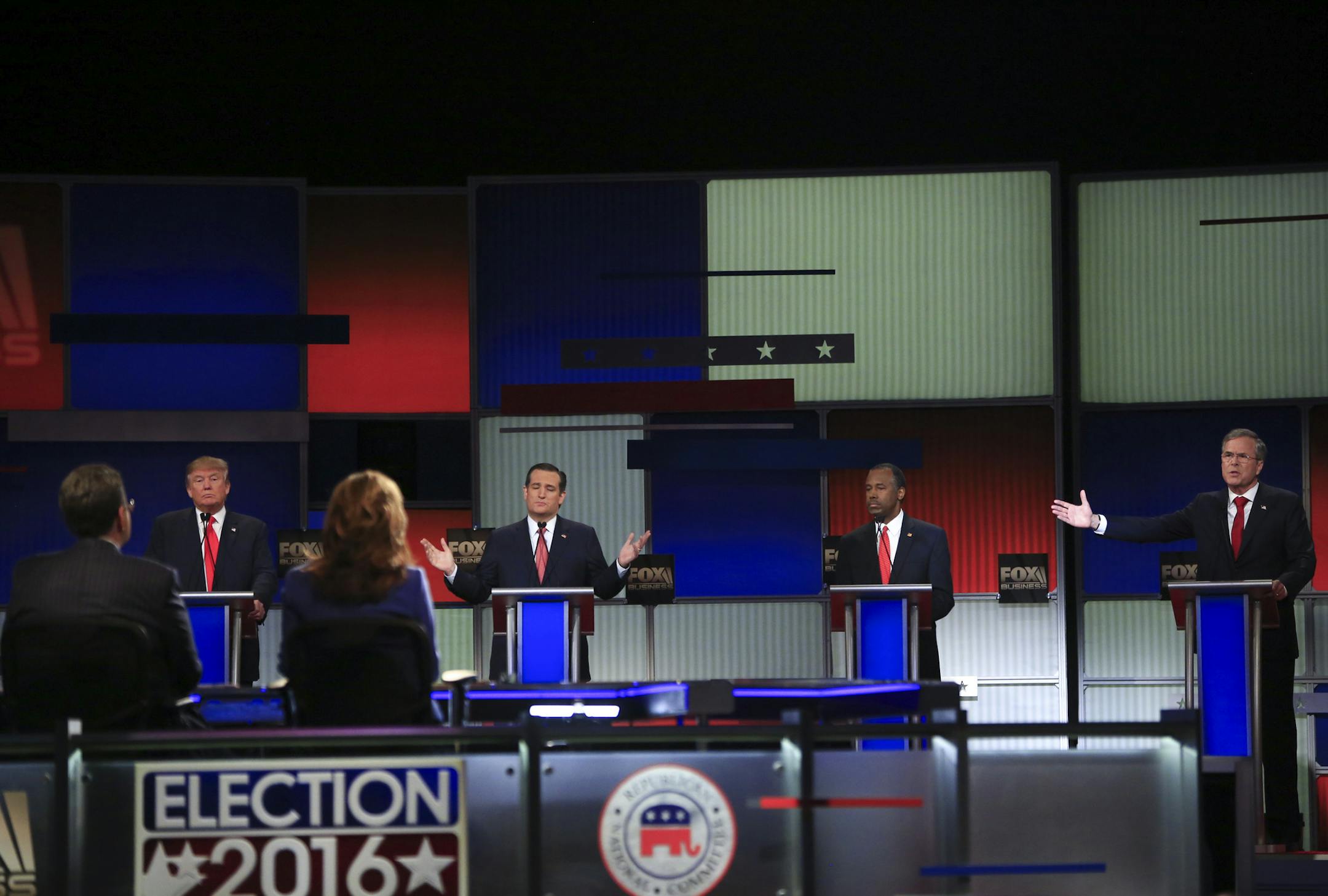From left: Donald Trump, Sen. Ted Cruz and Ben Carson react as Jeb Bush speaks during the Republican presidential primary debate, at the North Charleston Coliseum in North Charleston, S.C., Jan. 14, 2016. The next-to-last debate before the Iowa caucuses is being moderated by the Fox Business Channel. (Eric Thayer/The New York Times)