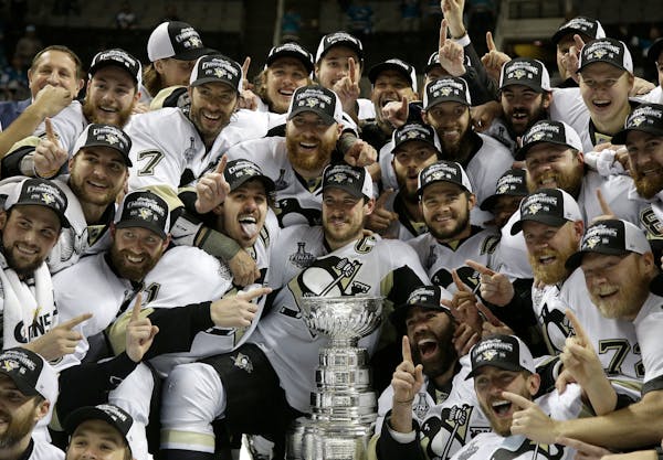 Pittsburgh Penguins players pose for photos with the Stanley Cup after Game 6 of the NHL Finals against the San Jose Sharks. Can the Penguins repeat w