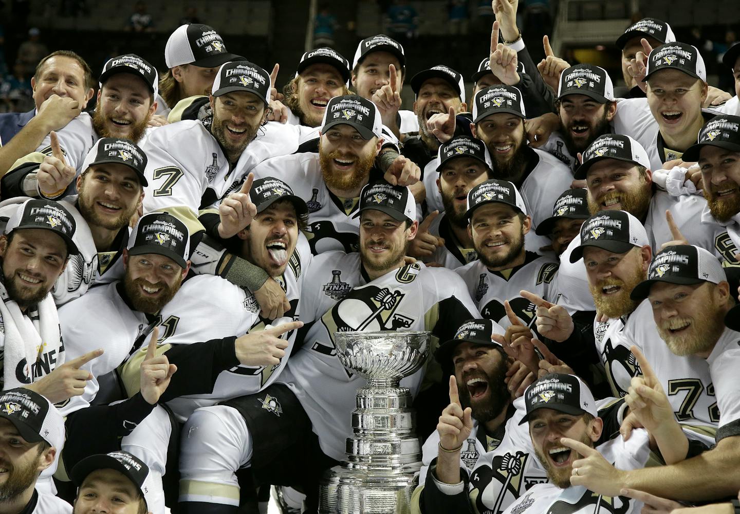 Pittsburgh Penguins players pose for photos with the Stanley Cup after Game 6 of the NHL Finals against the San Jose Sharks. Can the Penguins repeat with Sidney Crosby injured to begin the season?