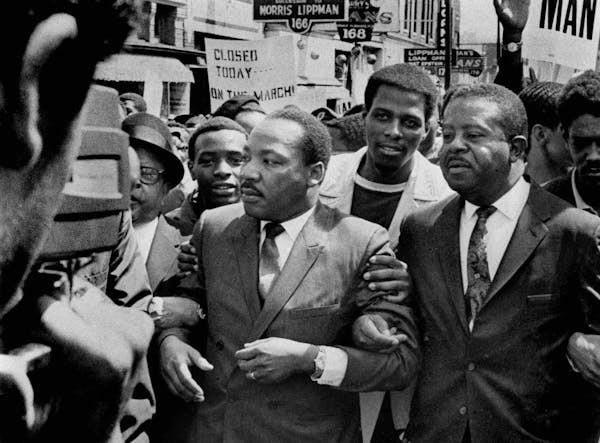 FILE -In this March 28, 1968 file photo, Dr. Martin Luther King Jr. and Rev. Ralph Abernathy, right, lead a march on behalf of striking Memphis, Tenn.
