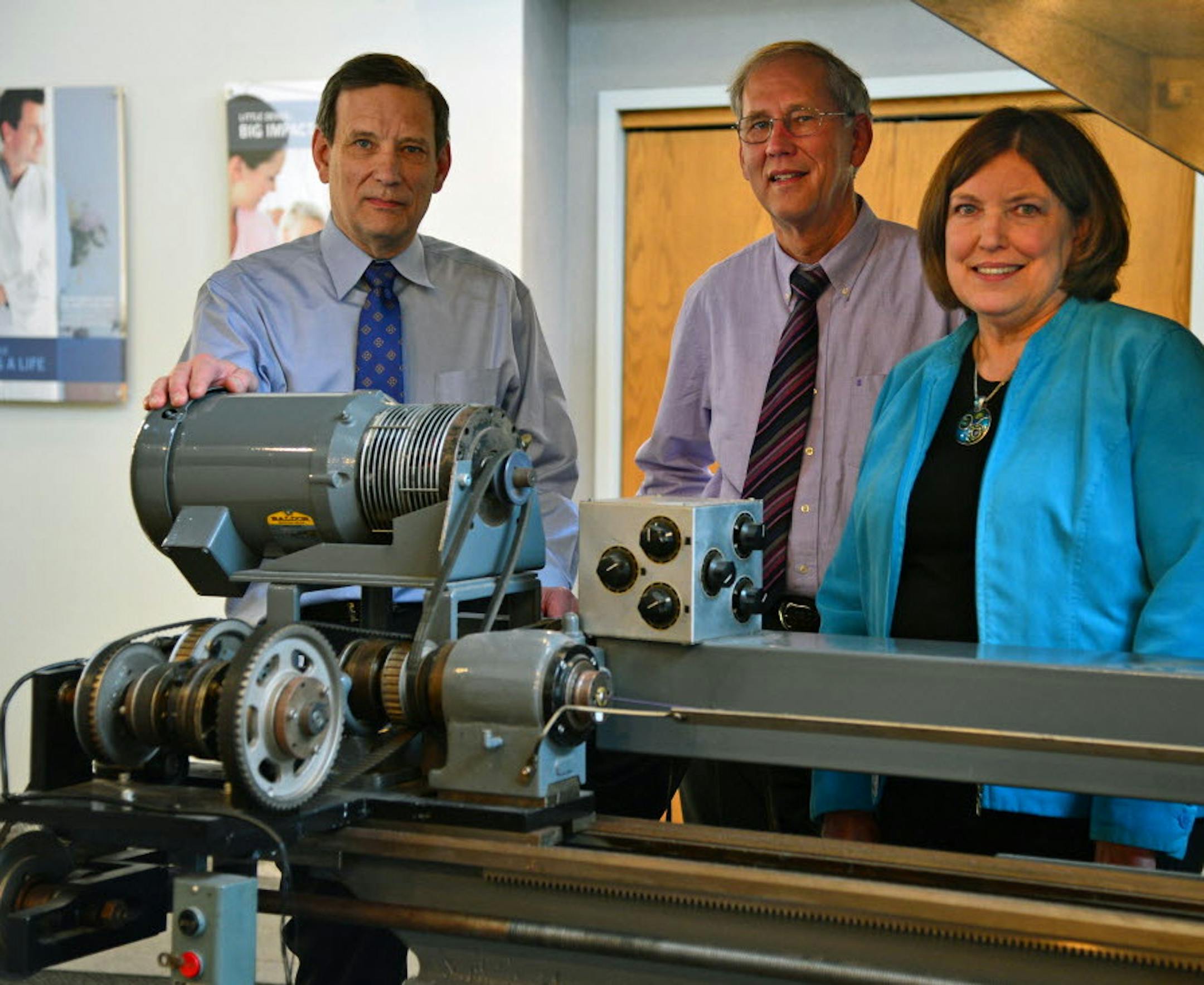 The children of Joe Fleischhacker, founder of Lake Region Medical, gathered in the manufacturing area of Lake Region Medical, which they sold to a larger company in the first quarter of 2014. They are from left to right Mark Fleischhacker, Joe Fleischhacker and Kate Roehl. This machine was was created in the 1960s by the late Joe Fleischhacker Sr. to spin wire for medical devices. Chaska-based Lake Region Medical went from Joe Fleischhacker's garage shop that made fishing tackle after World War
