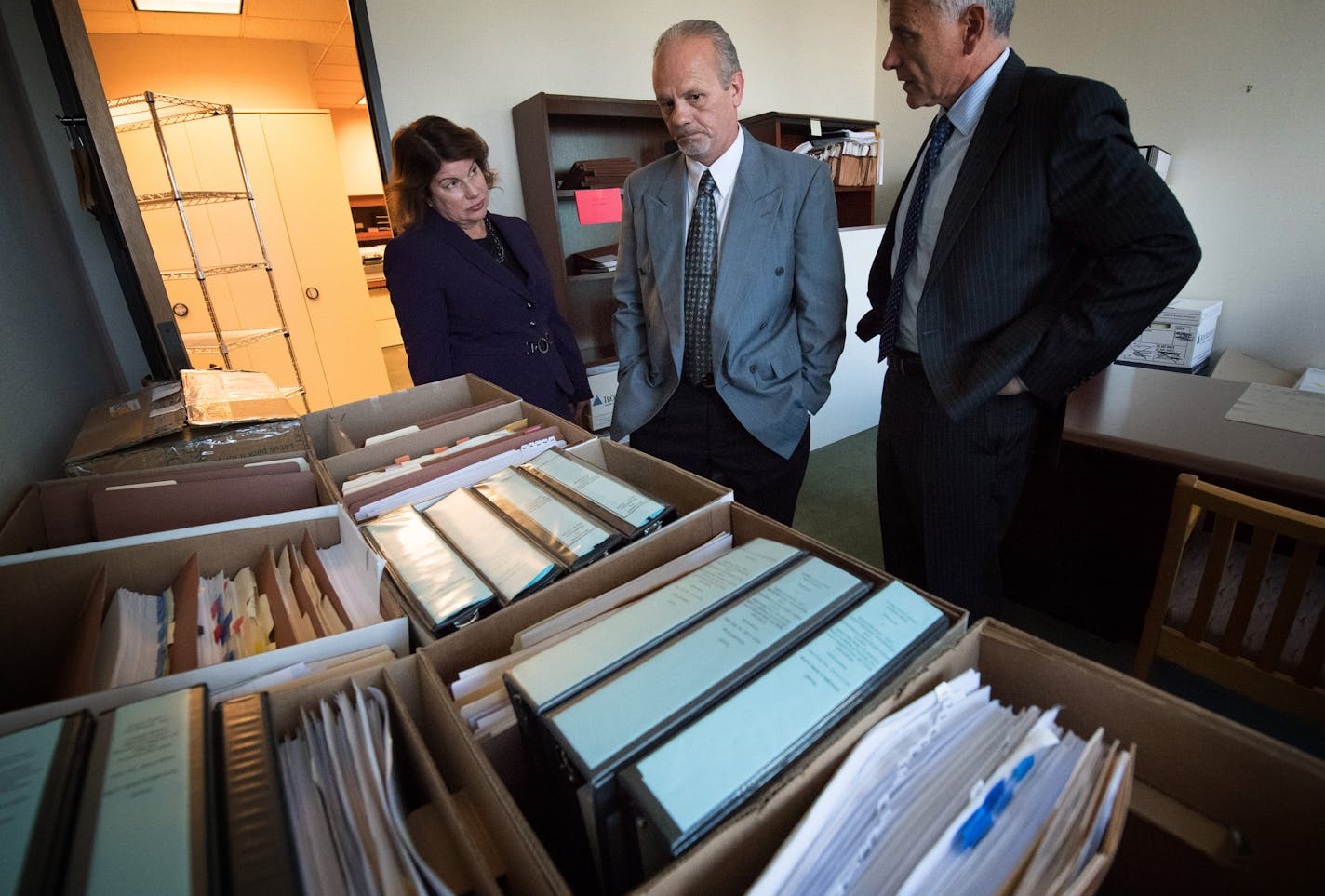 Flanked by Innocence Project lawyer Julie Jonas and Minneapolis attorney David Schultz, Terry Olson looked over 20 boxes of documents on his case.