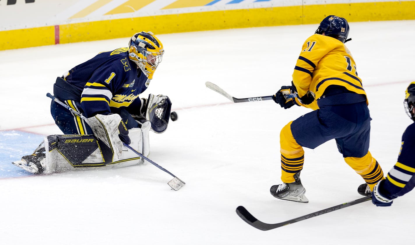 Michigan goalie Erik Portillo (1) blocks a shot by Collin Graf (11) of Quinnipiac in the second period Thursday, April 6, 2023, at Amalie Arena in Tampa, Fla. Michigan Wolverines vs. Quinnipiac Bobcats in the semi-finals of the NCAA Frozen Four. ] CARLOS GONZALEZ • carlos.gonzalez@startribune.com.