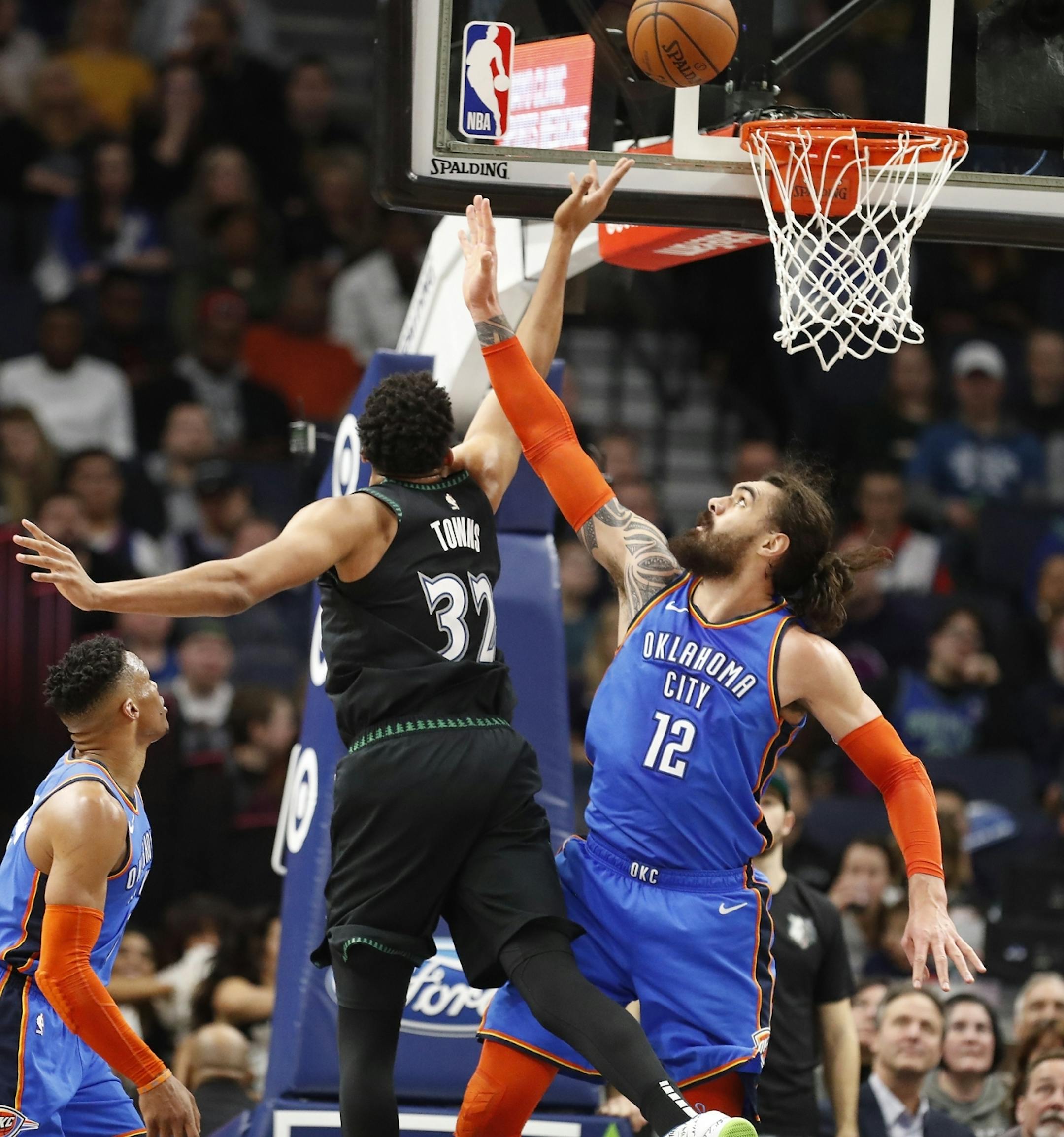 Minnesota Timberwolves center Karl-Anthony Towns (32) shoots as Oklahoma City Thunder center Steven Adams (12) during the second half.