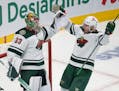 Wild goaltender Cam Talbot celebrates with Dmitry Kulikov after the Wild defeated Montreal