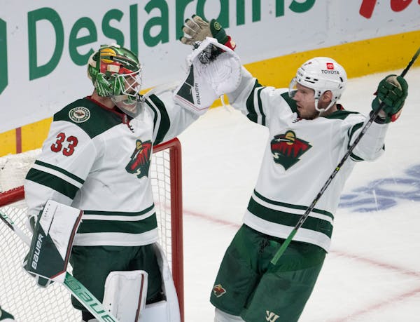 Wild goaltender Cam Talbot celebrates with Dmitry Kulikov after the Wild defeated Montreal