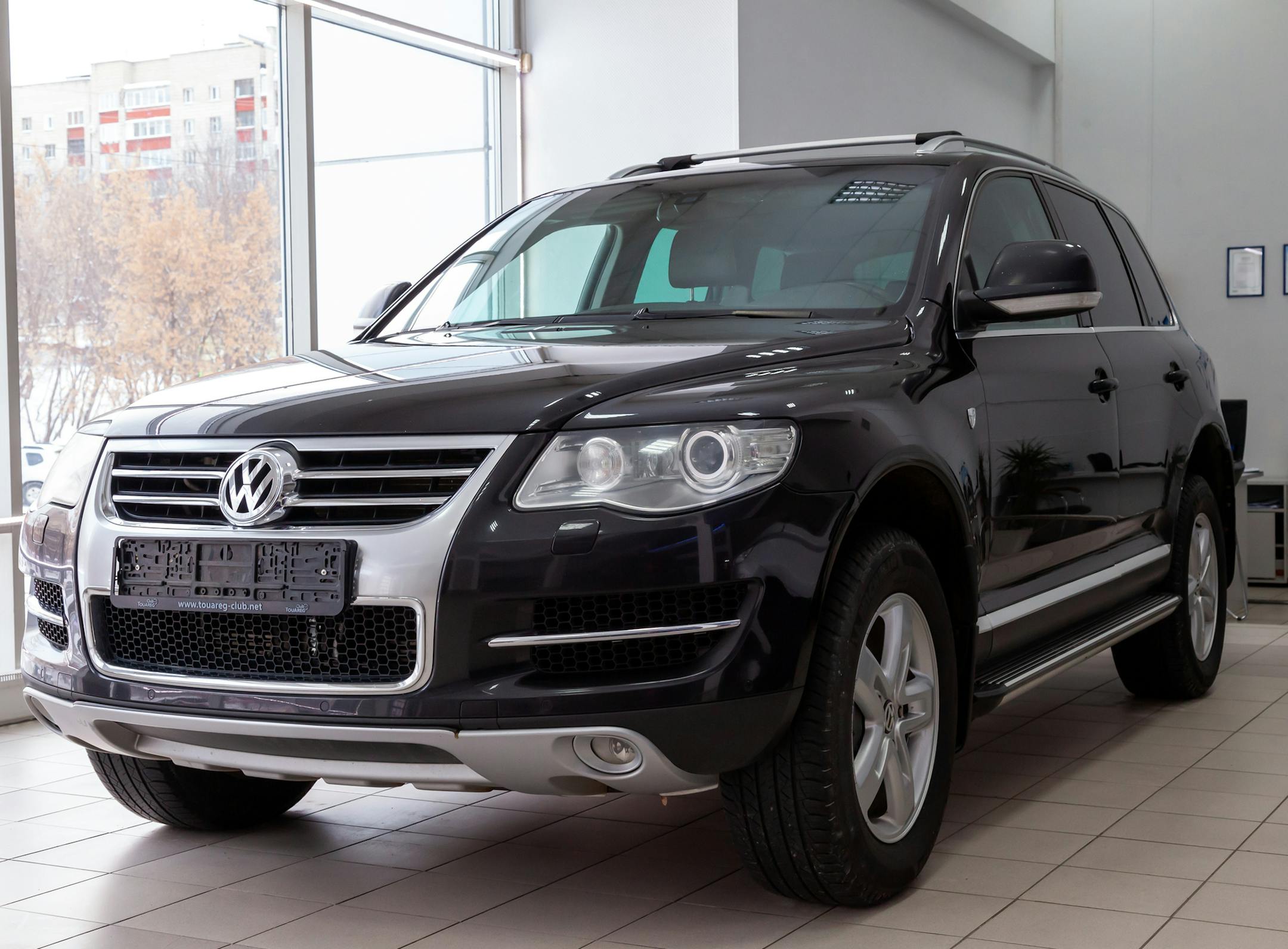 Novosibirsk, Russia - 08.01.2018: Black Volkswagen Touareg 2008 release with an engine of 6 liters W12 front view on the car parking in the service center.