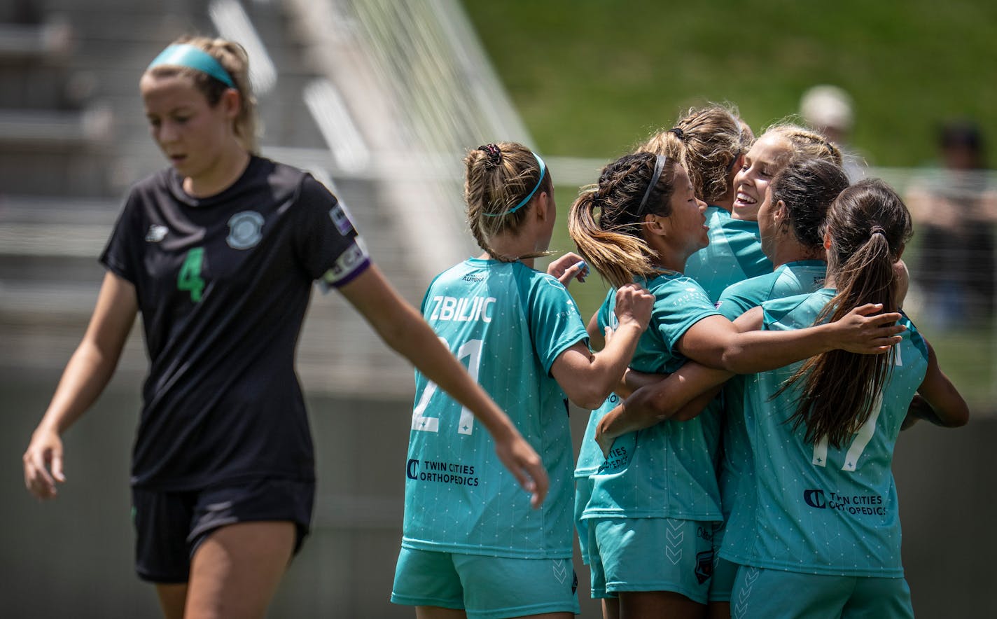 Riley Casey, of St. Louis walked away as Morgan Stone, center Minnesota Aurora teammates celebrates her first half goal in Eagan Minn., on Sunday June 26, 2022.