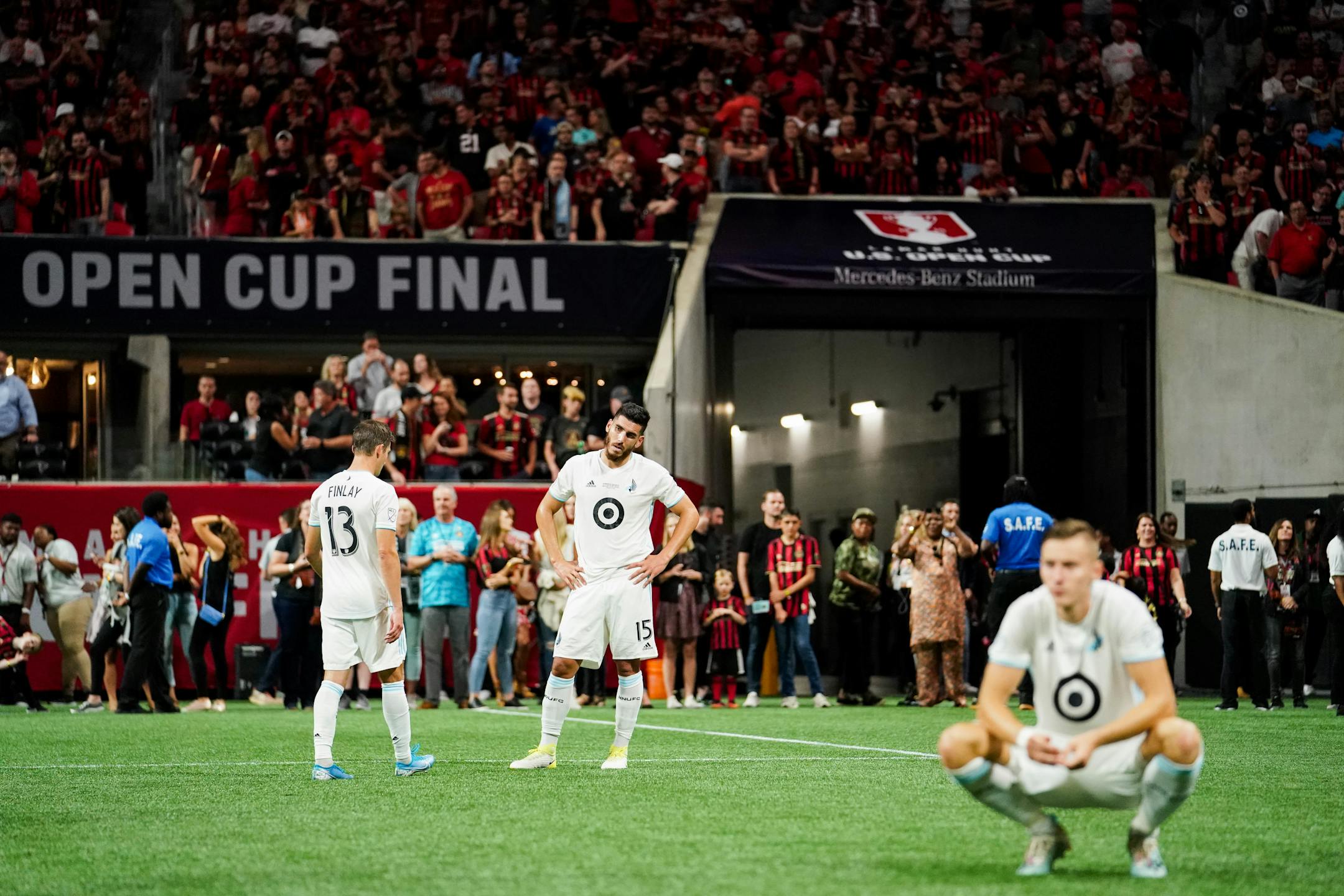 Minnesota United defender Michael Boxall (center) and teammates react after losing 2-1 to Atlanta United in the U.S. Open Cup at Mercedes-Benz Stadium on Tuesday