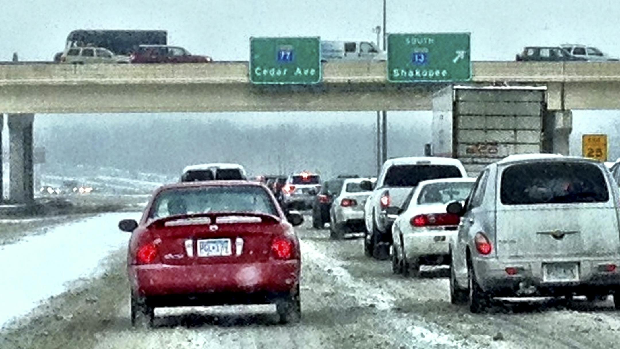 Traffic on northbound Cedar Av near the Minnesota River crossing, slow going because of m,orning snow / ice.
