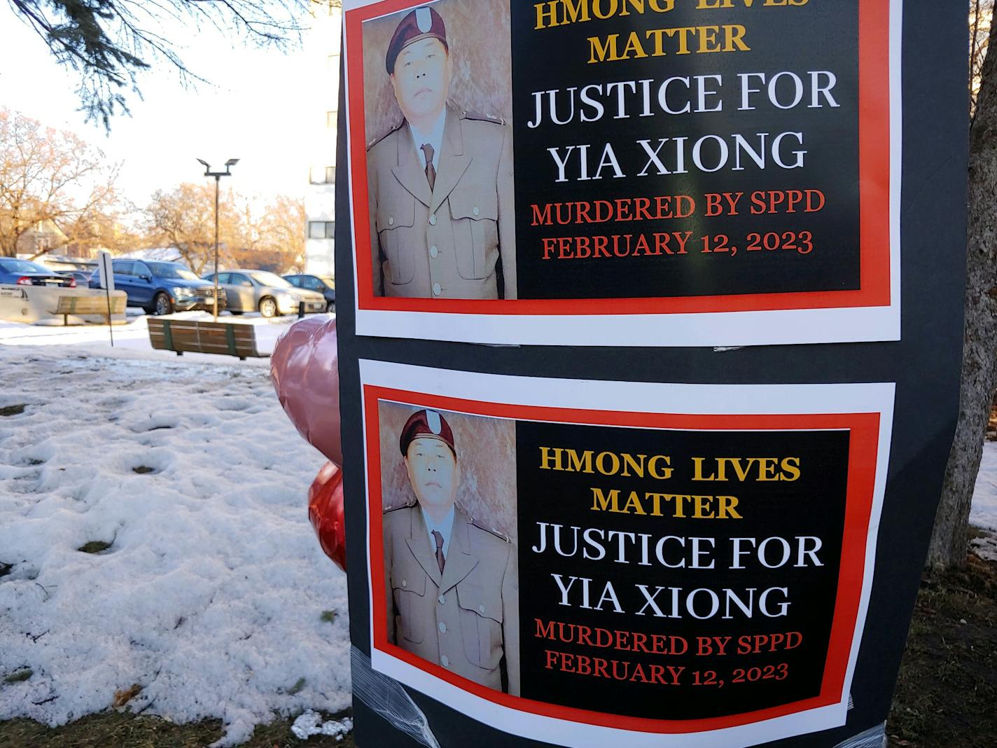 Signs bearing the photo of Yia Xiong were posted Sunday, Feb. 19, 2023, near the St. Paul apartment complex where the 65-year-old was shot and killed by St. Paul police on Feb. 11. (Erin Adler/Star Tribune)