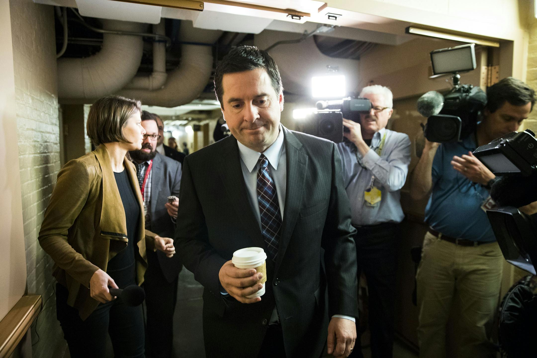 FILE — Rep. Devin Nunes (R-Calif.), chairman of the House Intelligence Committee, walks past reporters on Capitol Hill in Washington, March 28, 2017. Nunes was given reports showing that President Donald Trump and his associates were incidentally swept up in foreign surveillance by two Trump White House officials, according to a New York Times report of March 30. (Doug Mills/The New York Times)