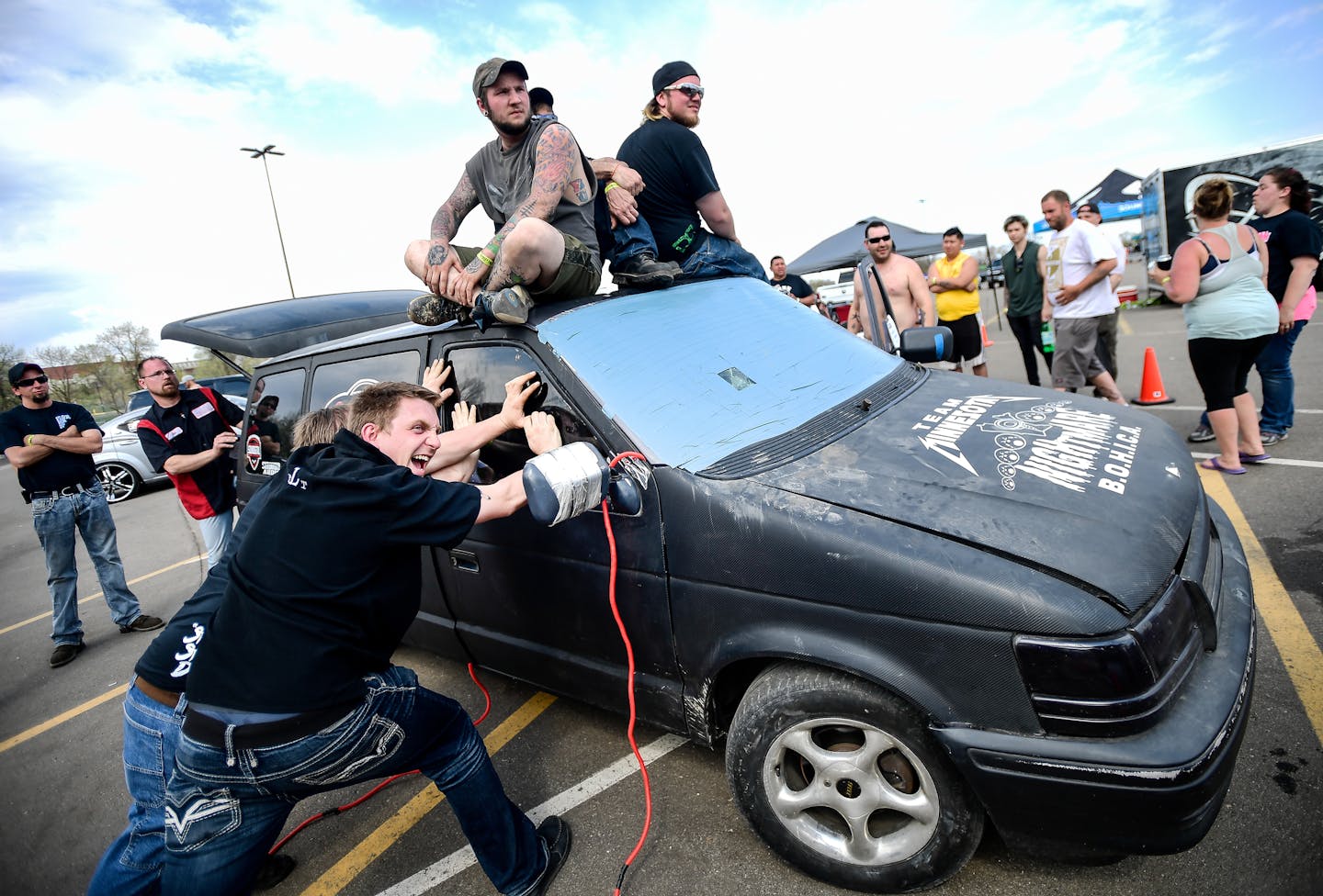 Paul Nazers, bottom left, reacted as the sound system in Dan Horner's 1993 Dodge Caravan was activated during an Advanced 3 contest at the State Fairgrounds.