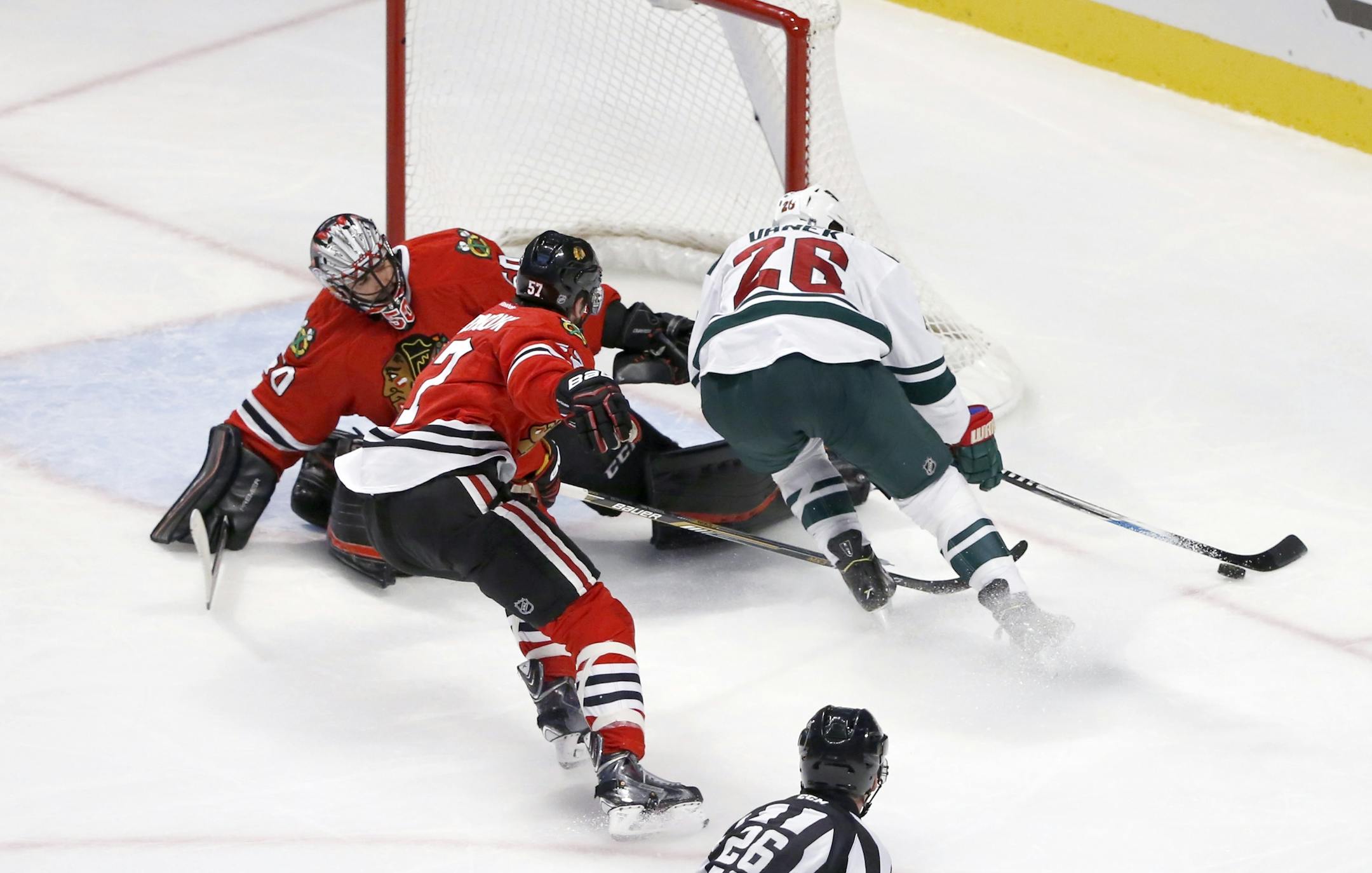 Minnesota Wild left wing Thomas Vanek (26) is unable to get a shot on goal as Chicago Blackhawks goalie Corey Crawford (50) and Trevor van Riemsdyk defend during the third period of an NHL hockey game Tuesday, Dec. 1, 2015, in Chicago. The Wild won 2-1. (AP Photo/Charles Rex Arbogast)