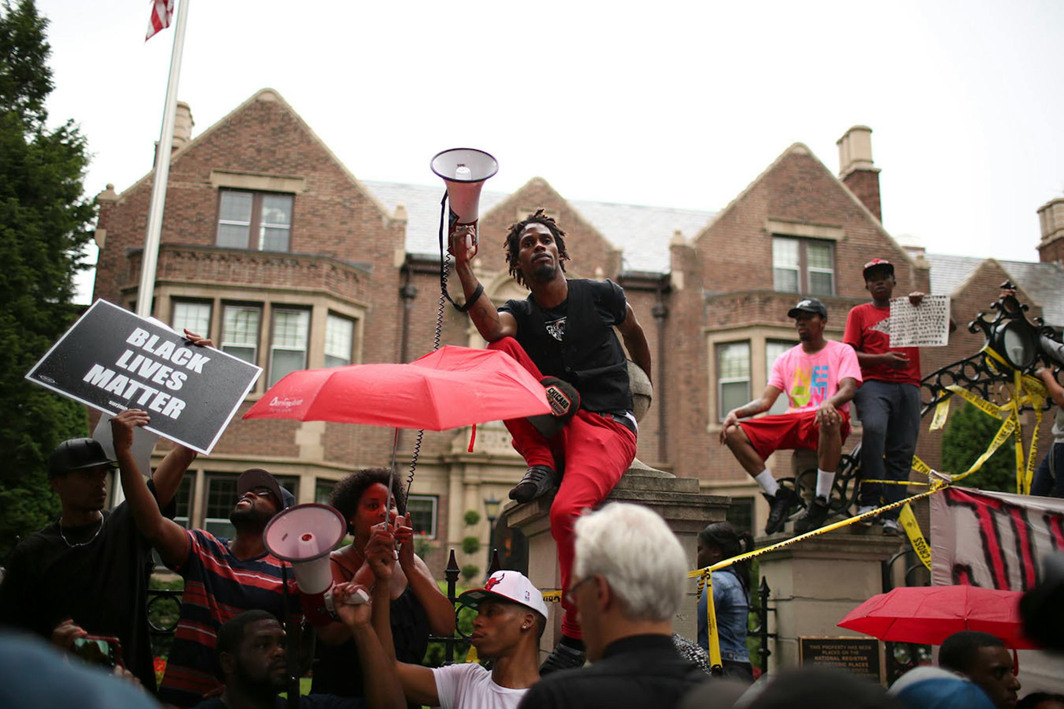 A speaker addressed the crowd with a makeshift public address system after marchers arrived at the Governor's Mansion.