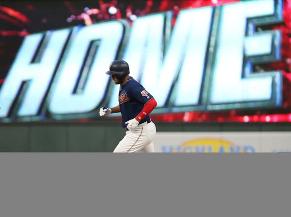 The Twins' Jonathan Schoop runs toward second base after hitting a home run against the Mariners
