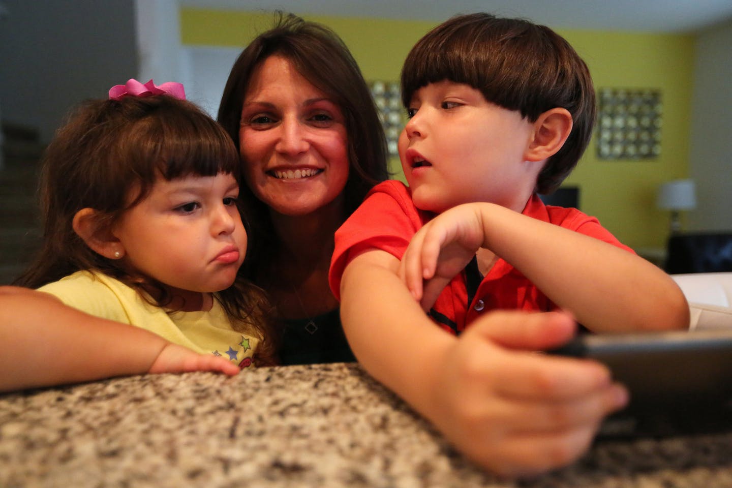 Lissette Lanza with her children Jason, 7, and Julie, 3; and her parents Frank and Maritza Asencio, at a rental home in Davenport, on Monday, Nov. 12, 2018.KeyVilla operates vacation homes in Miami and Orlando, and they created a listing of vacation homes for people with autism where little things, like the doorbell or the wall paint, is designed to be more soothing.