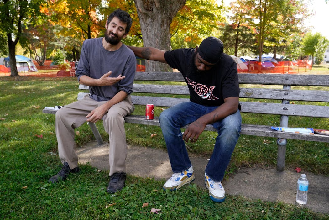 Newfound friends Brandon Harrison, left, and Brandon O'Neil Abrams have been living in Logan Park. Harrison has made significant strides in his battle against addiction. 