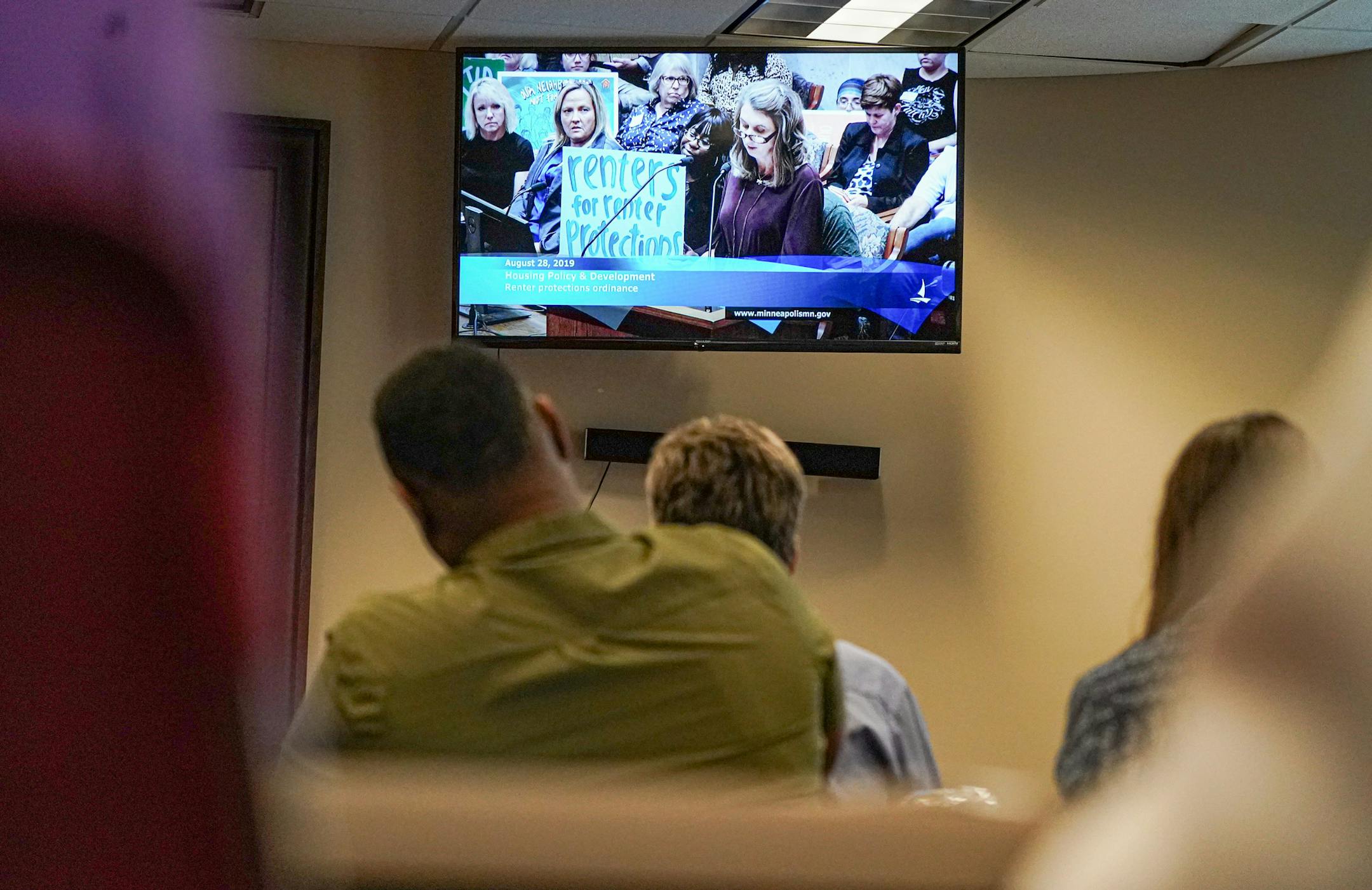 The overflow crowd watched as Nichol Beckstrand, president of the Minnesota Multi Housing Association, spoke on Wednesday.