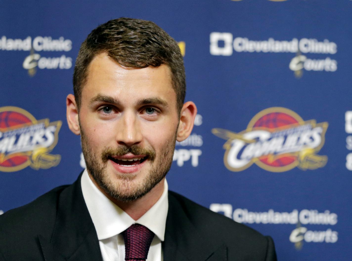 Cleveland Cavaliers' Kevin Love answers questions during his introductory news conference at the NBA basketball team's practice facility in Independence, Ohio Tuesday, Aug. 26, 2014. Love was acquired from the Minnesota Timberwolves in a three-team trade that was finalized over the weekend. (AP Photo/Mark Duncan)